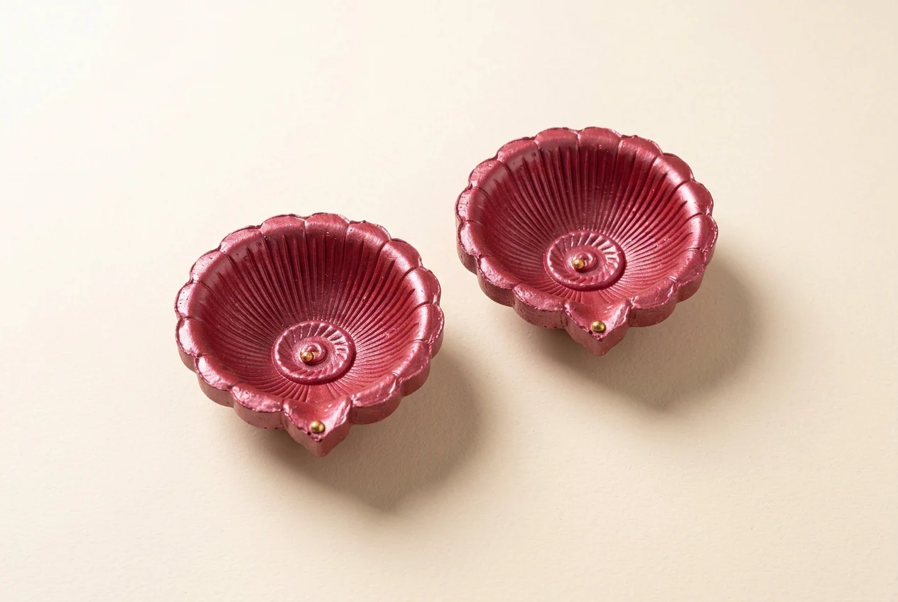 Rose Pink Diyas on a softly lit ivory surface